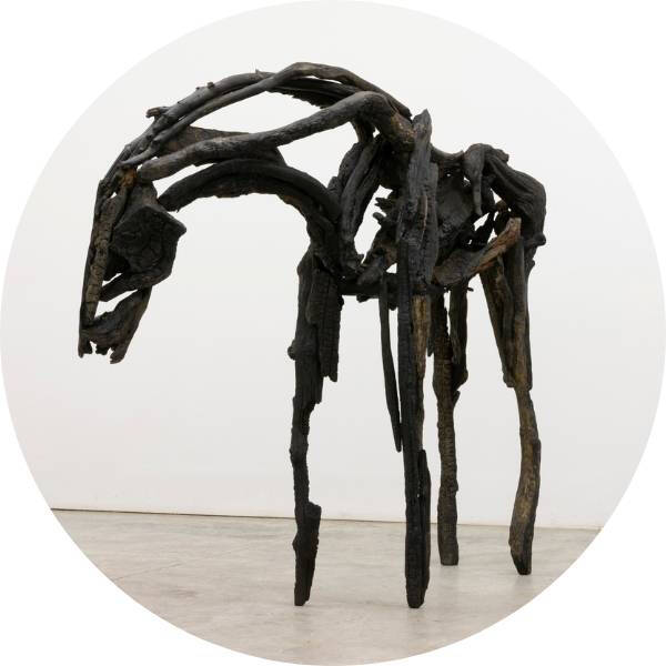 Bronze sculpture that looks like a horse created from wood.